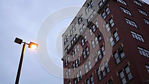 Establishing shot of red brick building on overcast evening