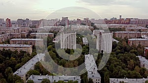 Establishing shot on the southwestern part of Moscow green district. Aerial view of the green area with old houses at