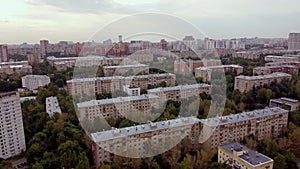 Establishing shot on the southwestern part of Moscow green district. Aerial view of the green area with old houses at