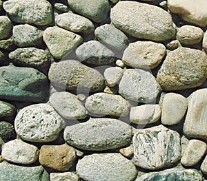 Round rocks embedded in the concrete photo