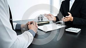 Estate agent broker presentating to client decision signing agreement contract real estate with approved mortgage application,