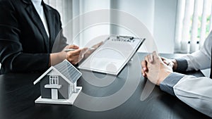 Estate agent broker presentating to client decision signing agreement contract real estate with approved mortgage application,