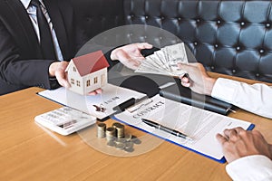 Estate agent broker receive money from client after signing agreement contract real estate with approved mortgage application form
