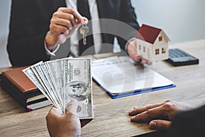 Estate agent broker receive money from client after signing agreement contract real estate with approved mortgage application form