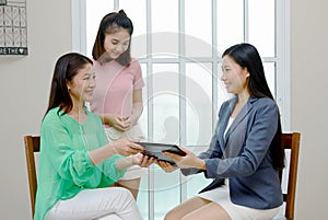 Estate agent close a contract.Asian family buying new home, business and people concept