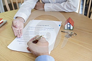 Estate agent with customer after contract signature of buying house