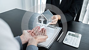 Estate agent giving house and keys to client after signing agreement contract real estate with approved mortgage application form