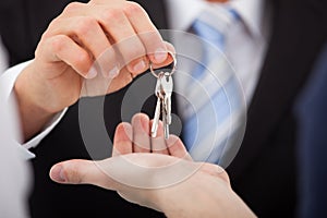 Estate agent giving house keys to man