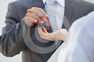 Estate agent giving the key to buyer