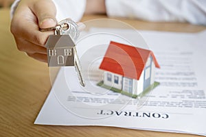 Estate agent handing over house keys