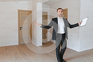 Estate Agent Looking Around Vacant Property For Valuation