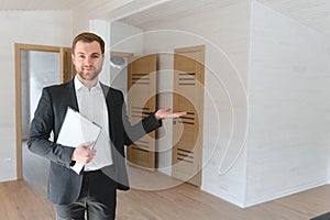 Estate Agent Looking Around Vacant Property For Valuation