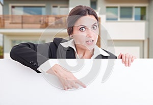 Estate agent pointing on blank cardboard