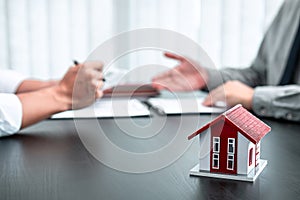 Estate agent are presenting home loan to client and discussing to decision signing agreement contract form, Home Insurance and