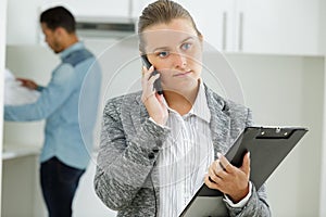 Estate agent receiving serious news on telephone
