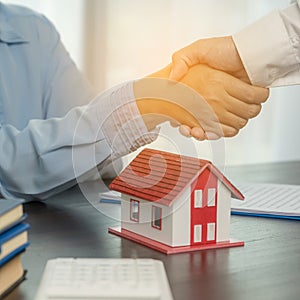 Estate agent shaking hands with client after contract signature and done business deal for transfer right of property. Man broker