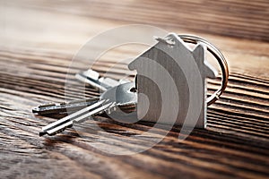 Estate concept, Key ring and keys on wooden background