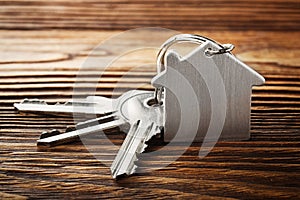 Estate concept, Key ring and keys on wooden background