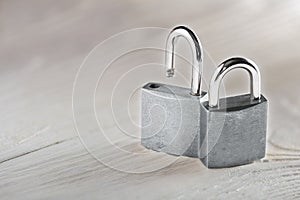 Estate concept with symbol of security, lock padlock with key on wooden background.
