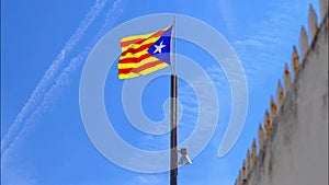 Estelada flag of Catalonia in Spain, red and yellow stripes with five-pointed star in triangle. Symbol of independence in