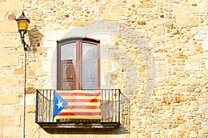 The Estelada starred flag hanging out of a building in Catalonia