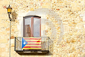 The Estelada starred flag hanging out of a building in Catalonia photo