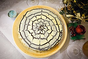 Esterhazy cake with a gift box on the round plate