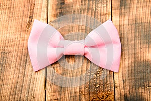 Esthete detail. Modern formal style. male bow tie on wood. vintage and retro style. Groom wedding. Wedding accessories