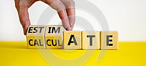 Estimate or evaluate symbol. Businessman turns wooden cubes and changes the word `evaluate` to `estimate`. Beautiful yellow an