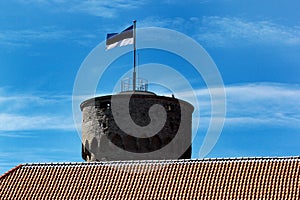 Estonian flag on Tall Hermann Tower in the Old Town of Tallinn, Estonia