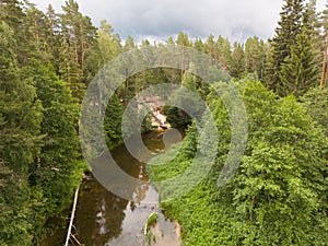 Estonian nature in summer, a drone view of the Valge river flowing through the forest, with a place for swimming