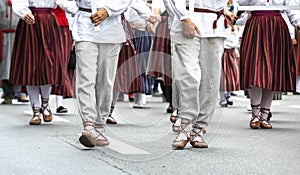 Estonian people in traditional clothing walking the streets of Tallinn