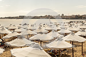 Estoril beach lined with white cloth umbrellas on a clear summer