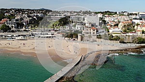 Estoril beach in Lisboa Portugal near casino and railroad station. Aerial drone
