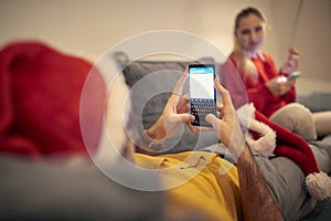 Estrange couple at home for christmas, using their cell phones