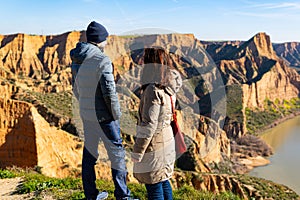 estranged angry couple think about their divorce in breathtaking scenery of mountains and red cliffs photo