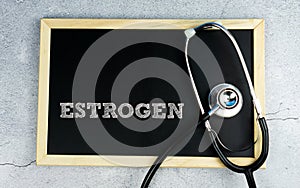 ESTROGEN wrote on chalkboard with stethoscope