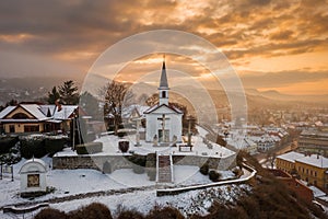 Esztergom, Hungary - Amazing golden sunrise at the Sorrowful Virgin Chapel on a misty winter photo