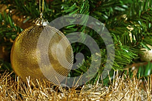 Etail of golden decoration on the christmas tree with gold chain.