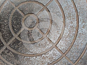 An etched metal plate with deep round ridges.