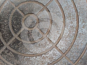 An etched metal plate with deep round ridges. photo