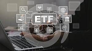 ETF,Exchange traded fund.Businessmen using a laptop with icons of ETF.Business finance concept.Stock market index fund