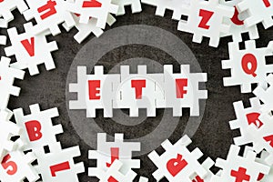 ETF, Exchange Traded Fund concept, white puzzle jigsaw with alphabet ETF at the center, a type of investment fund that is traded photo