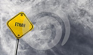 Ethan - yellow sign with cloudy background photo