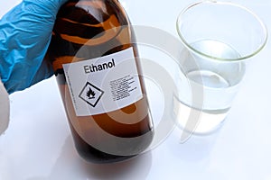 Ethanol in glass,Hazardous chemicals and symbols on containers in industry photo