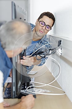 Ethernet cable being plugged into wall socket