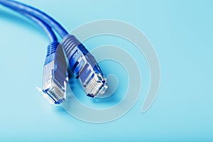 Ethernet Cable connector Patch cord cord close-up on a blue background with free space