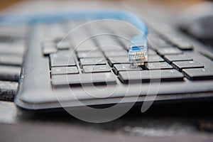 Ethernet cable plug connector on computer laptop keyboard technology concept