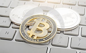 Etherum, Bitcoin, Ripple on the keyboard