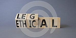 Ethical and Legal symbol. Turned wooden cubes with words Ethical and Legal. Beautiful grey background. Business and Ethical and